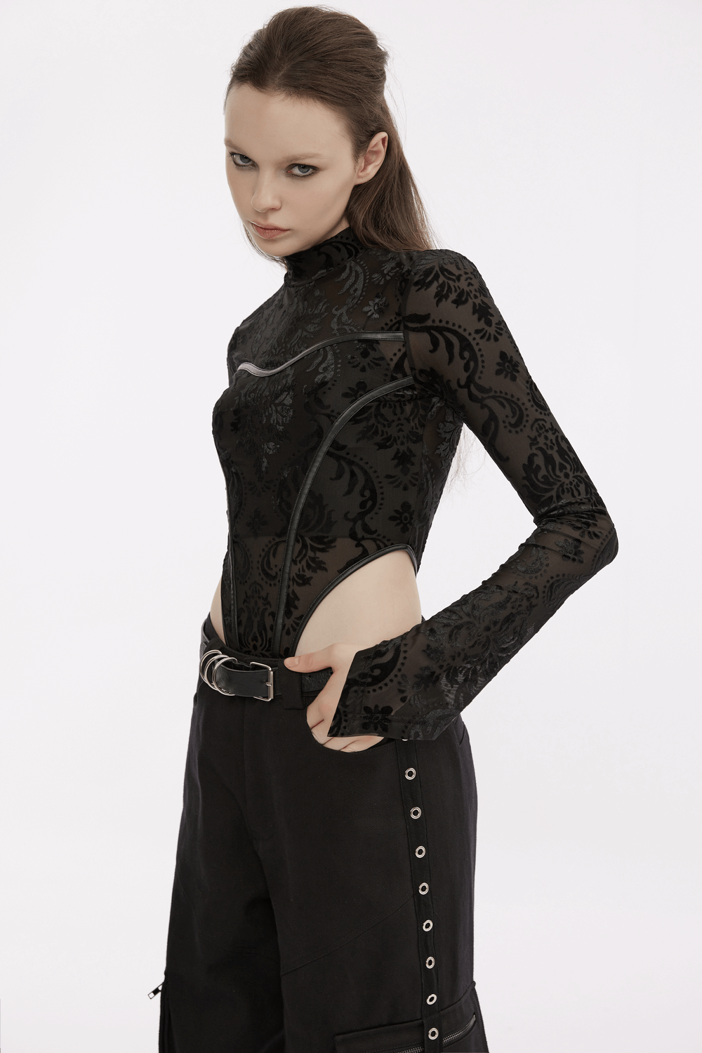 Fashionable black bodysuit with floral design paired with edgy cargo pants, showcasing a stylish urban look.