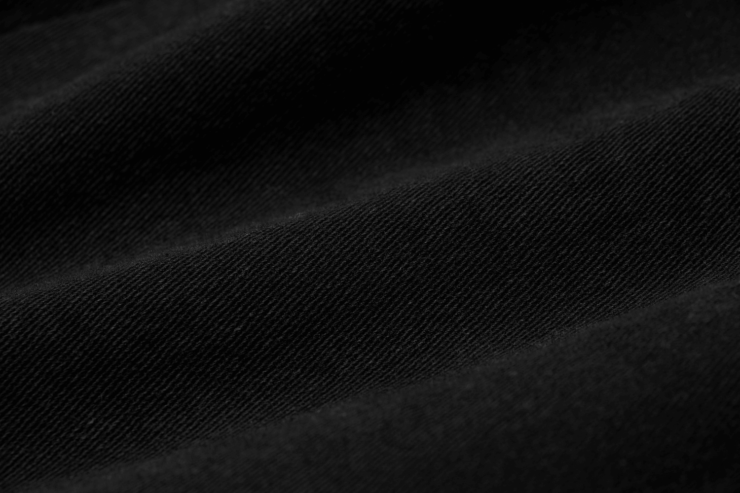 Close-up of black elastic woven fabric showcasing a textured design, perfect for stylish cargo trousers.