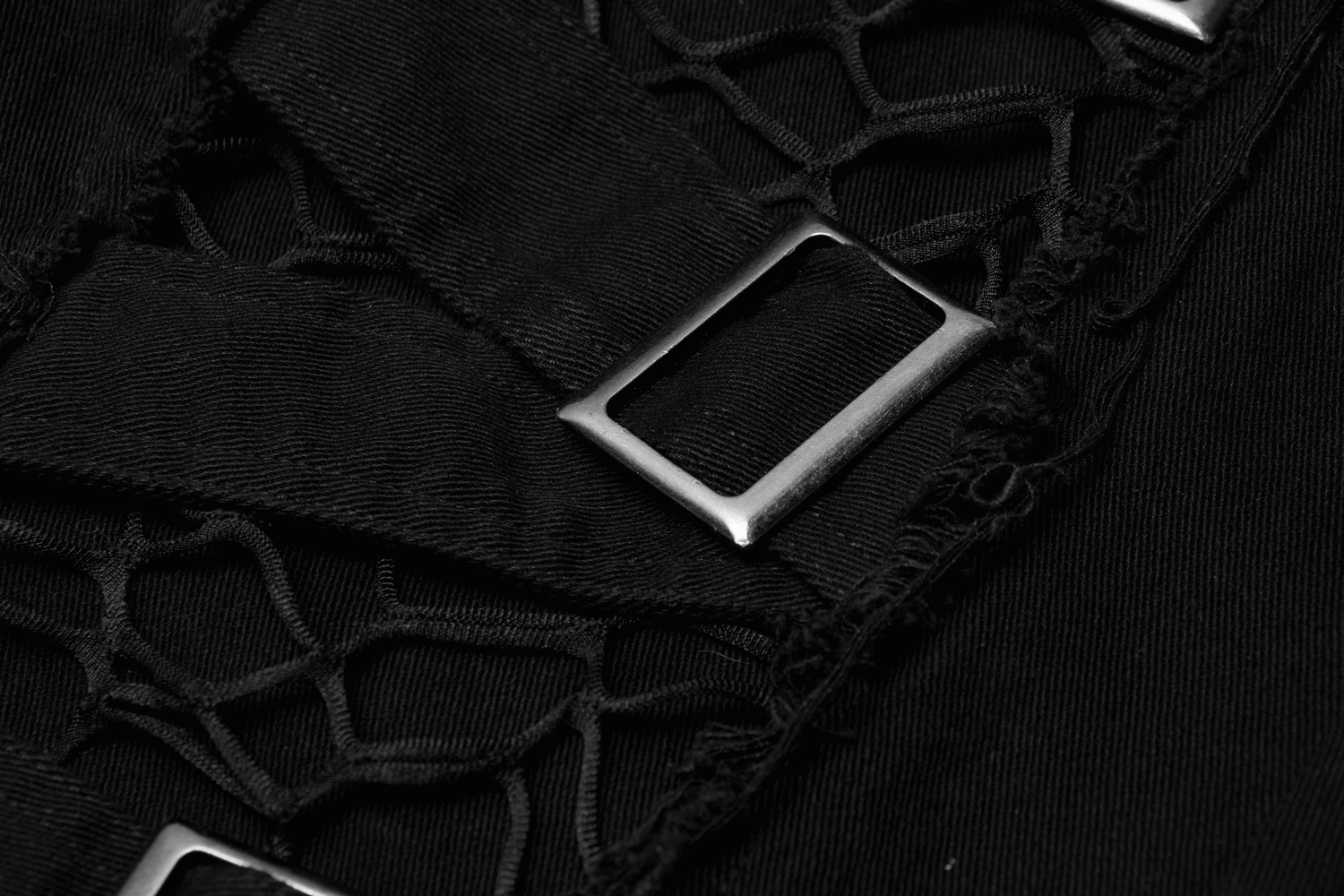 Close-up of black mesh and strap detail with silver buckles on Urban Gothic cargo pants for an edgy look.