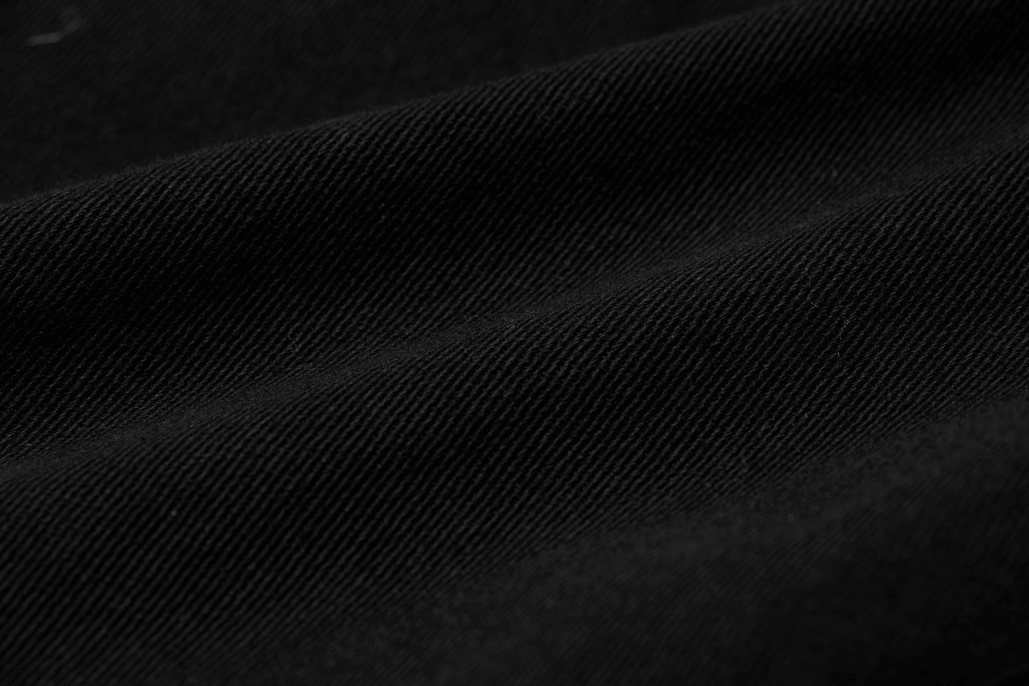 Close-up of elastic twill fabric in rich black, showcasing texture for Urban Gothic cargo pants.