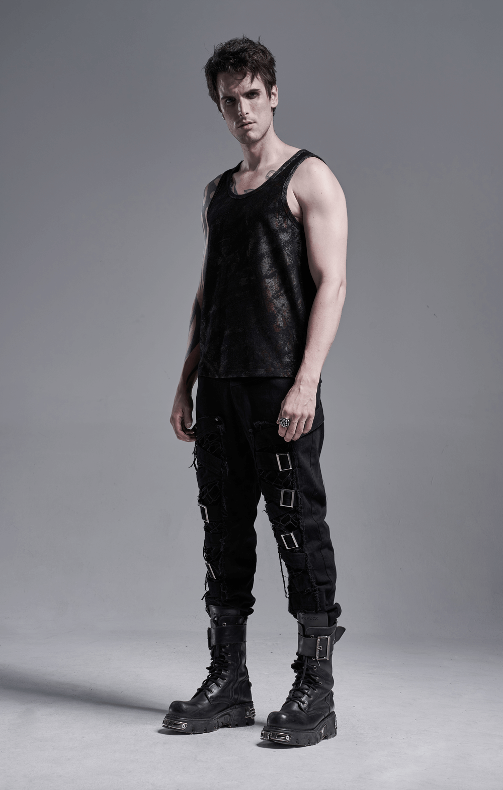 Model wearing Urban Gothic Buckled Strap Cargo Pants paired with a trendy black tank and combat boots.