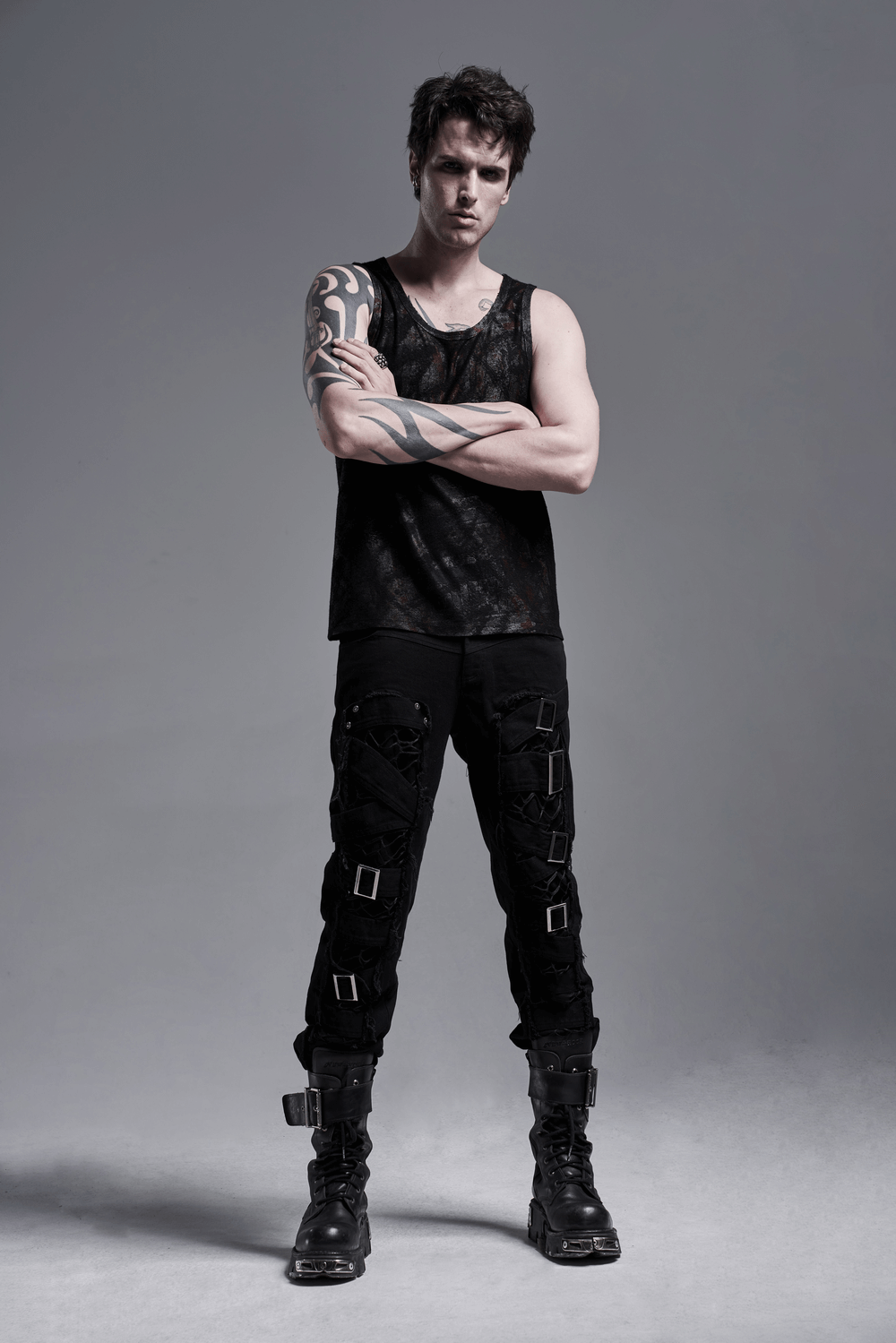Stylish model in edgy Urban Gothic Buckled Strap Cargo Pants paired with a black tank top, showcasing punk-inspired fashion.