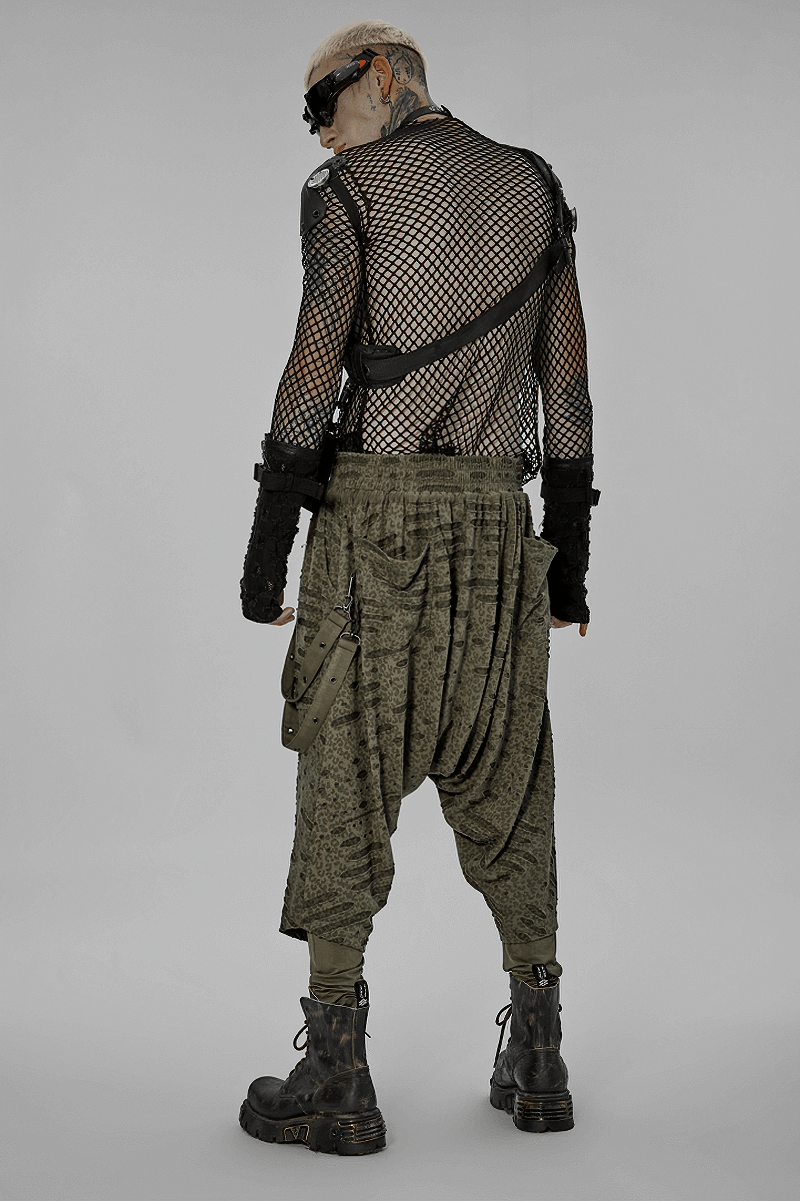 Edgy model showcasing Urban Gothic Harem Pants with detachable straps, styled with a fishnet top and combat boots.