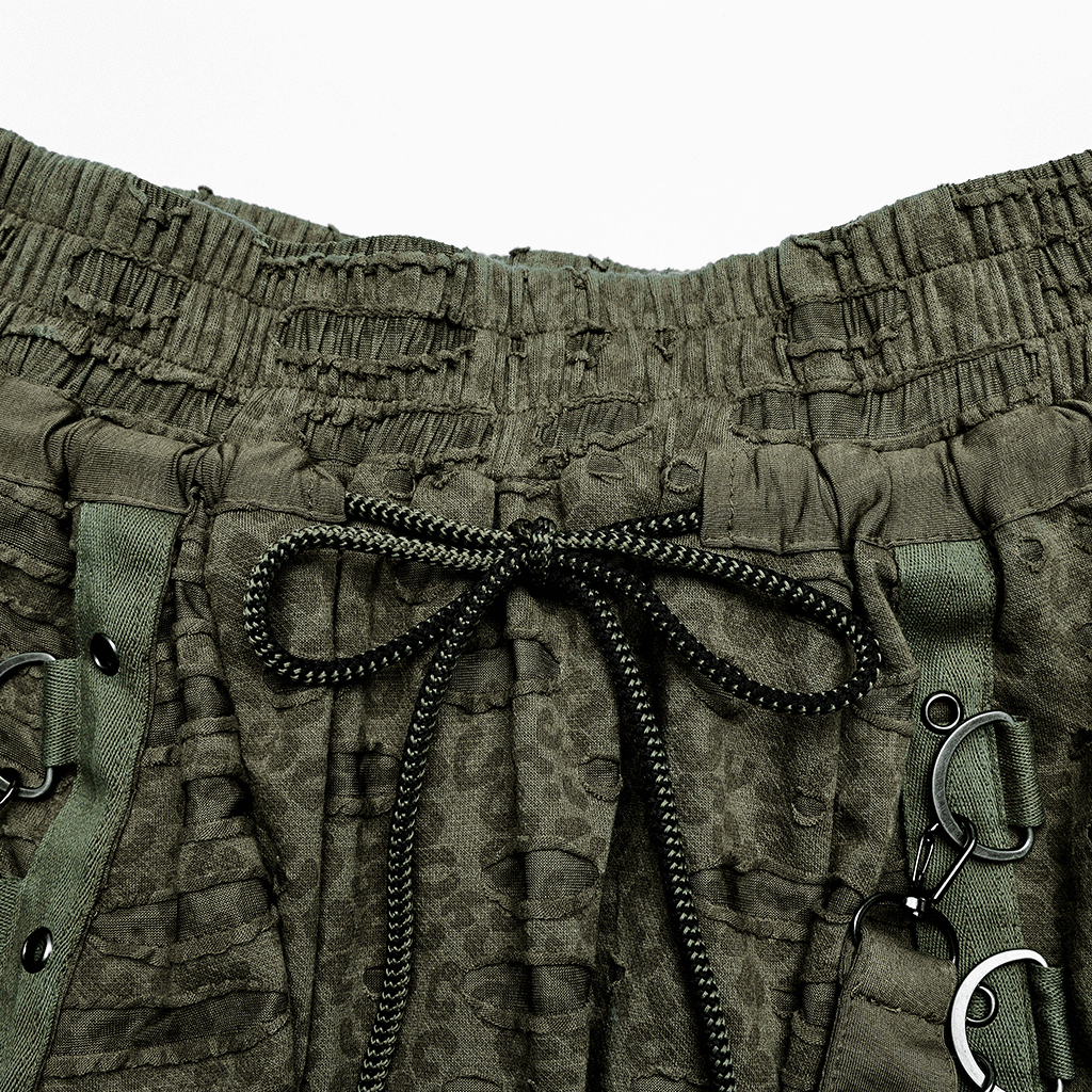 Close-up of urban gothic harem pants waistband showcasing drawcord and detachable straps for adjustable fit.