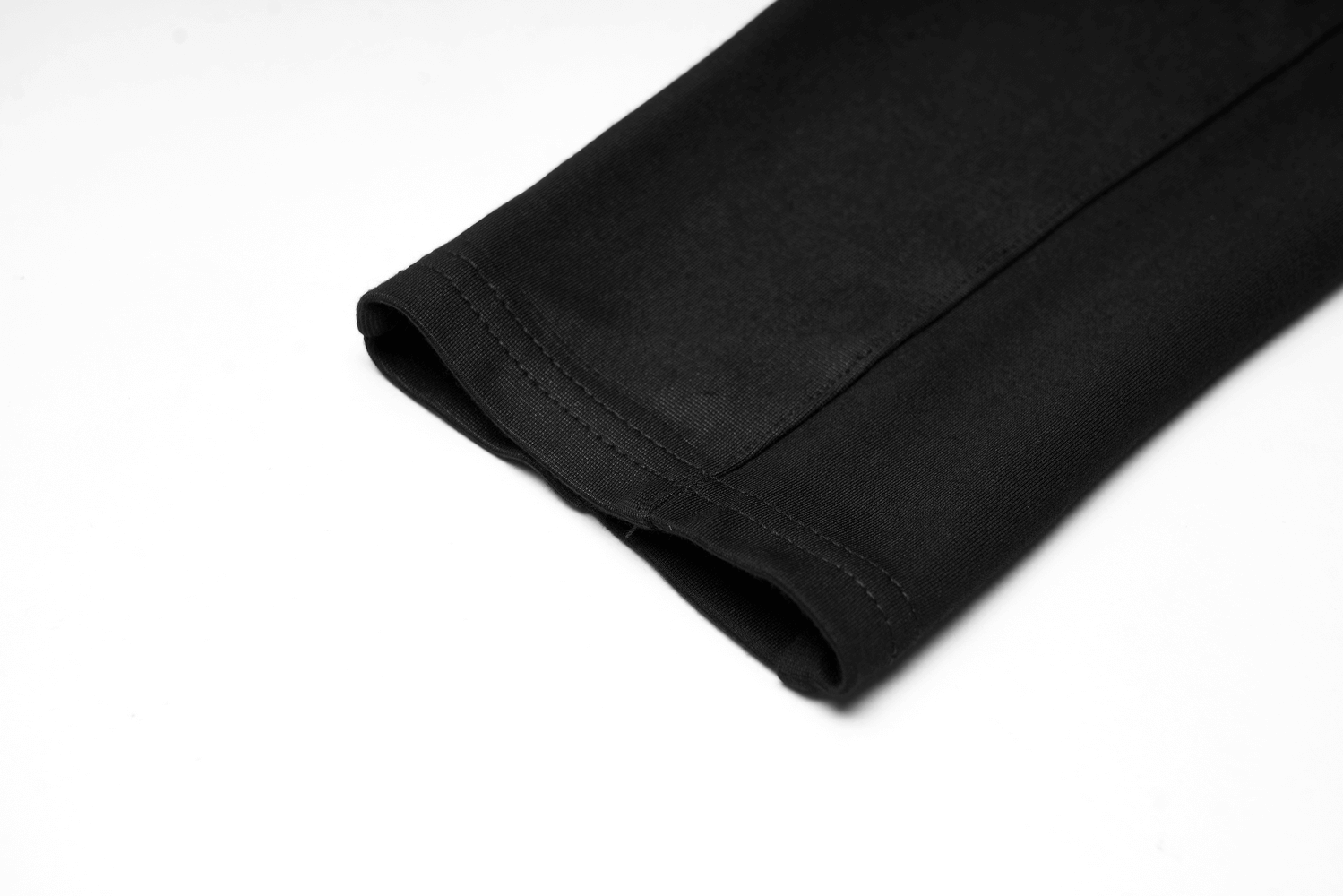 Close-up of the hem of Urban Punk black leggings featuring smooth fabric and sleek finish.