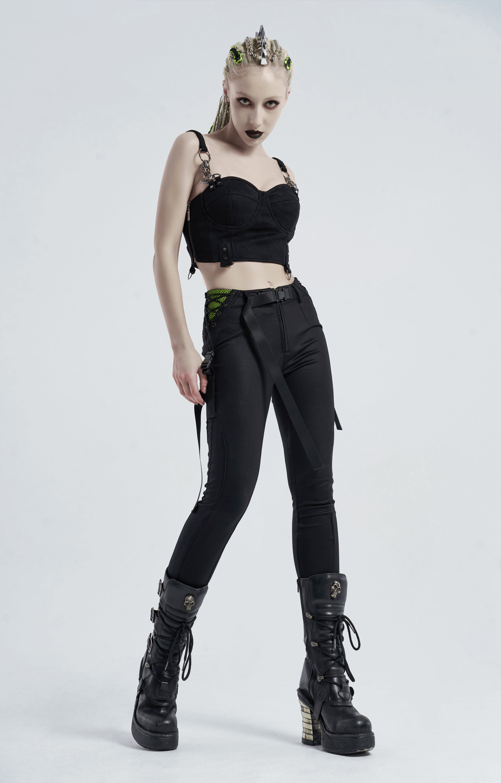 Urban punk model wearing black leggings with zipper and bandage details, showcasing edgy fashion vibes.