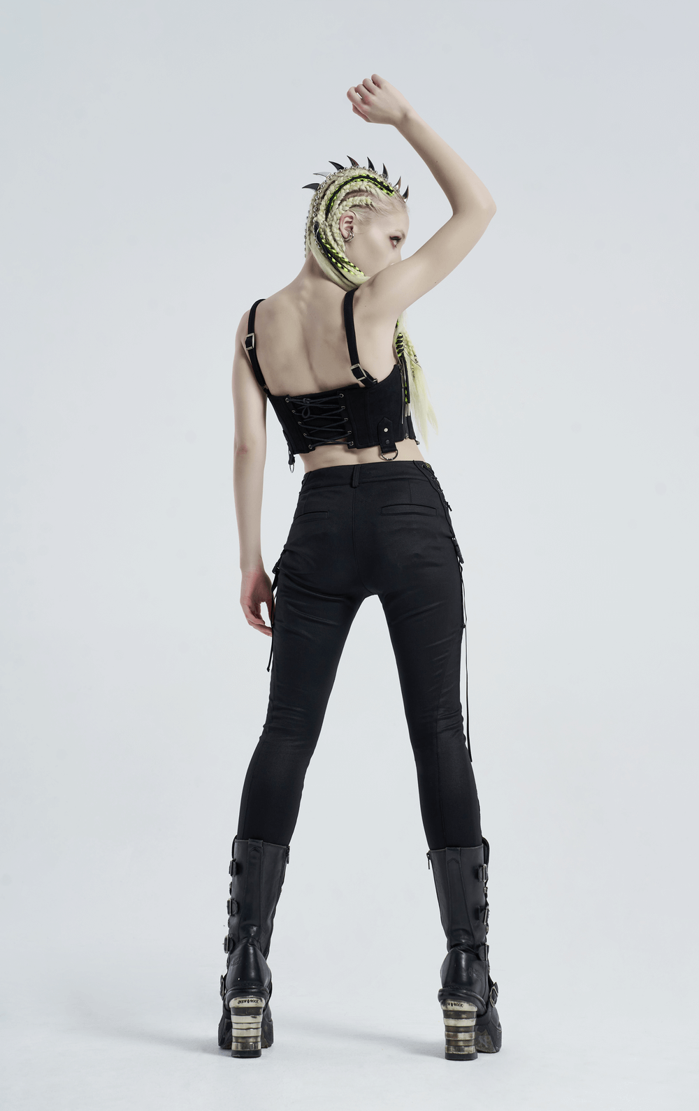 Back view of model in Urban Punk black leggings with zip and bandage details, showcasing edgy fashion style.