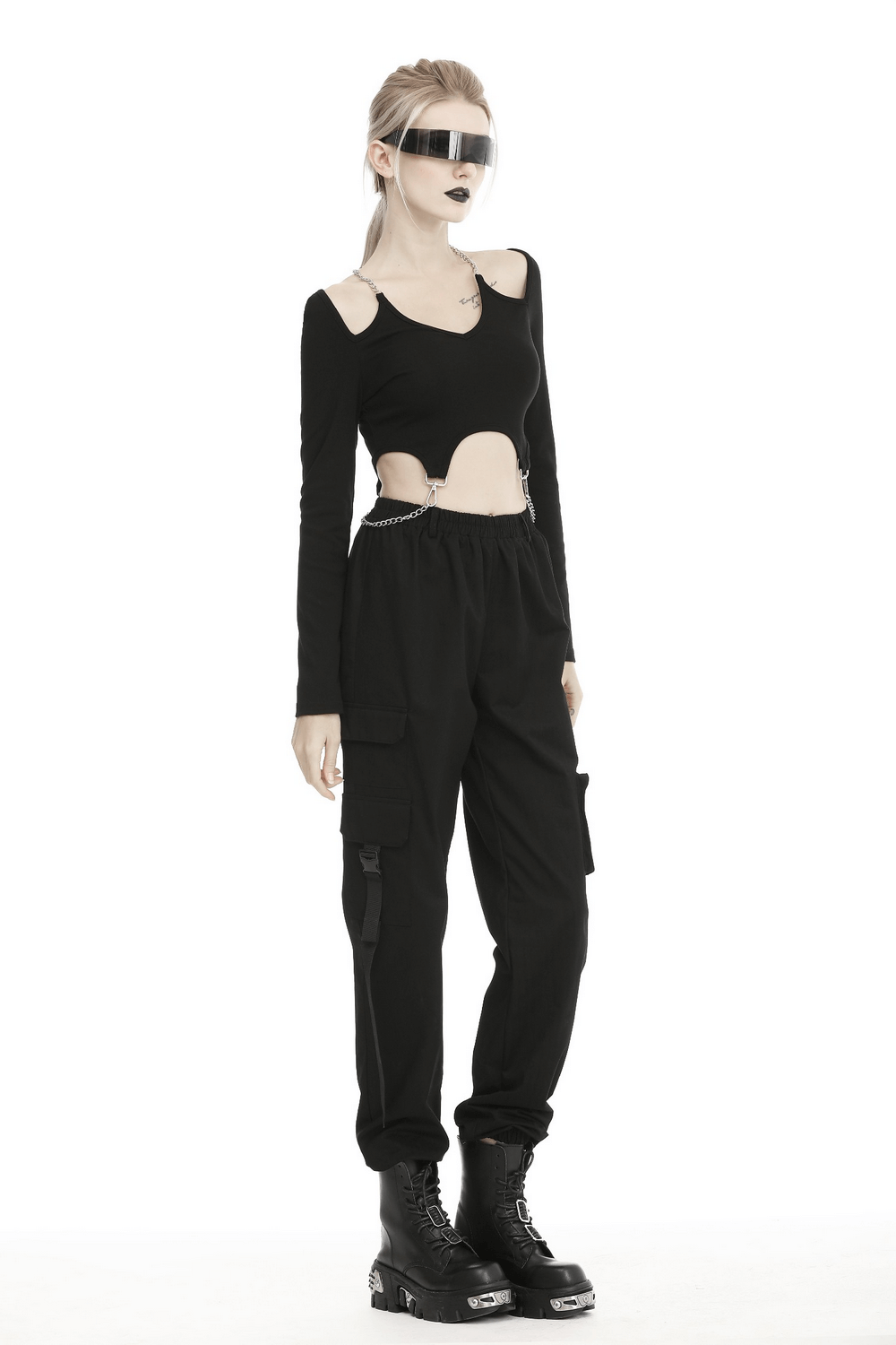 Trendy urban-style black cargo pants with spacious pockets, styled with an edgy cut-out top and futuristic goggles.