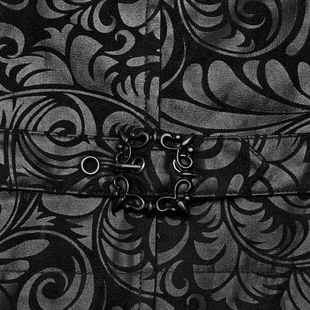 Close-up of embossed black Gothic waistcoat with intricate pattern and unique button detail.