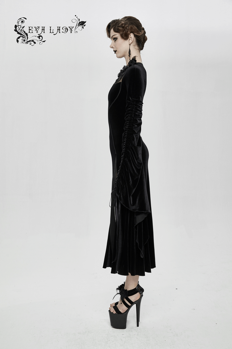 Elegant woman's velvet black dress with filigree patterns, showcasing gothic style and wide adjustable sleeves.