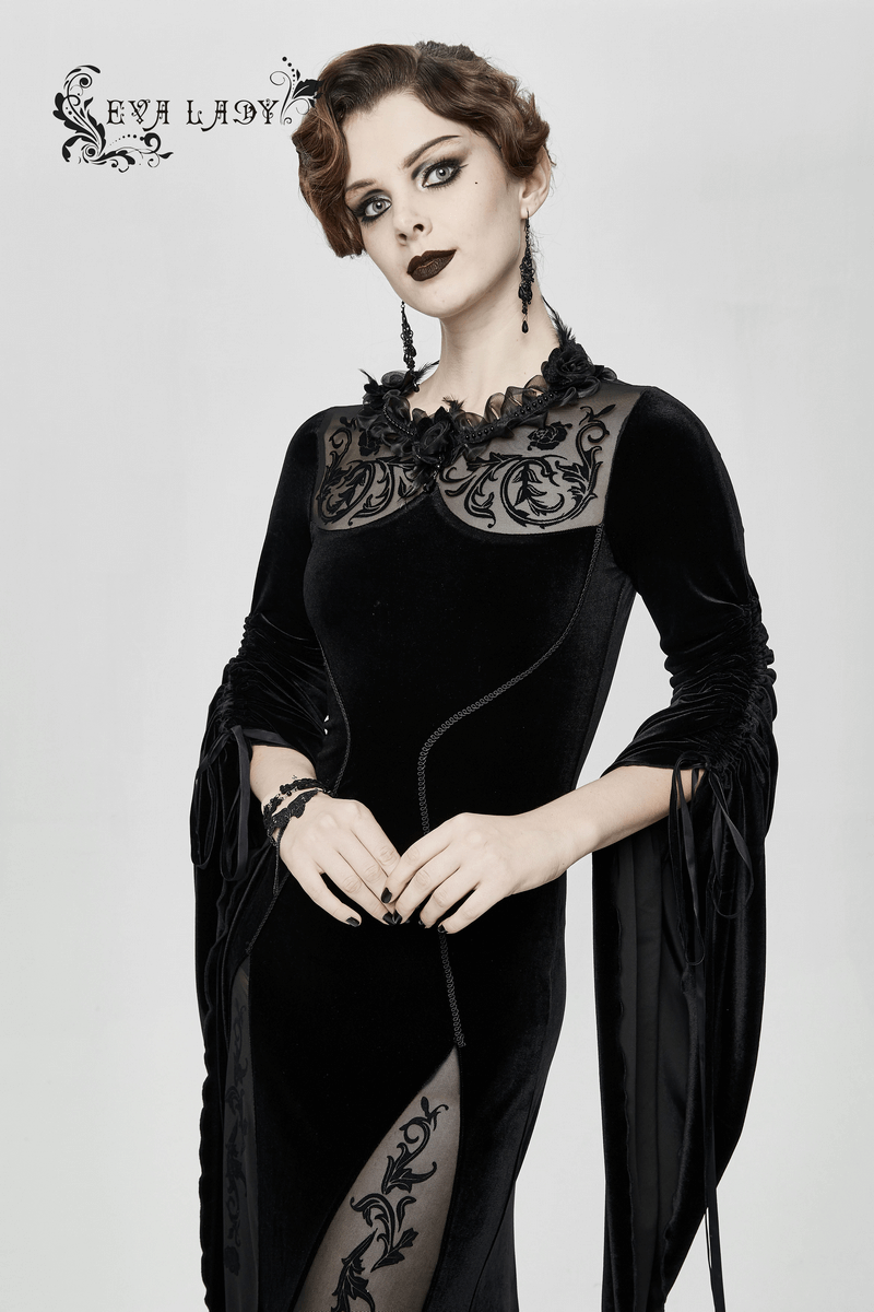 Gothic elegant women's velvet black dress with filigree patterns and wide sleeves, showcasing a striking model.