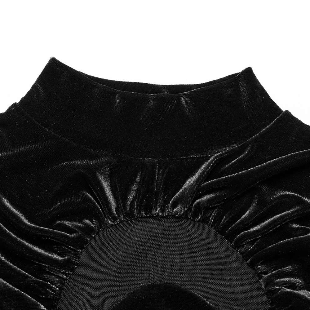 Close-up of the stand-up collar and crescent cut-out design of a black velvet top, showcasing its elegant texture.