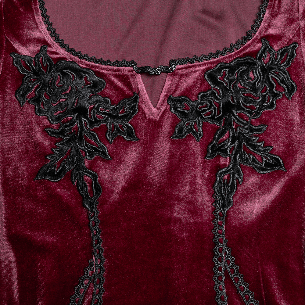 Close-up of velvet dress with black rose embroidery and lace detailing on neckline.