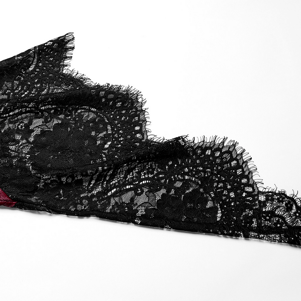 Close-up of delicate black lace fabric, showcasing intricate patterns and soft texture, perfect for gothic fashion.