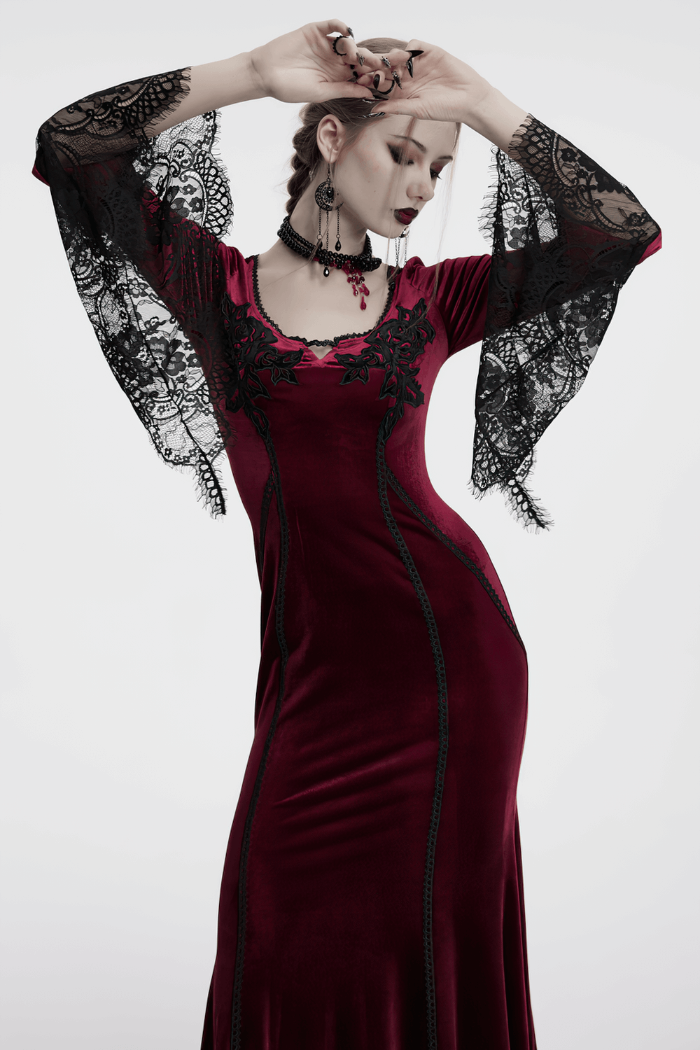 Gothic velvet dress with lace bell sleeves and rose embroidery, perfect for dark romantic fashion.