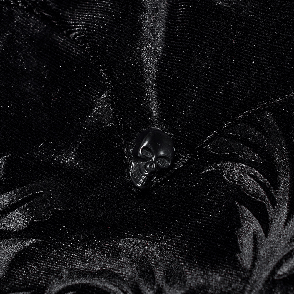 Close-up of a black skull button on a velvet embossed gothic shirt, showcasing intricate details and elegant design.
