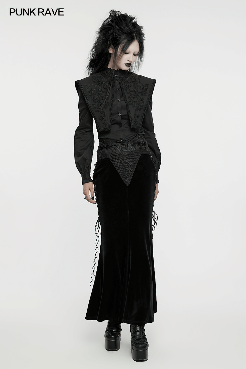 Gothic woman in black velvet fishtail skirt with 3D rose buckle and embroidered top, showcasing elegant punk fashion.