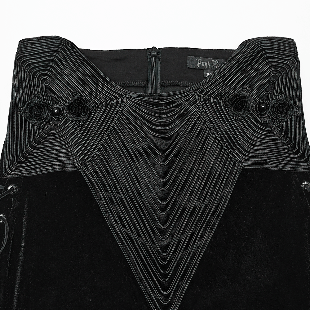 Close-up of black velvet fishtail skirt featuring intricate U-shaped embroidery and 3D rose buckle details.