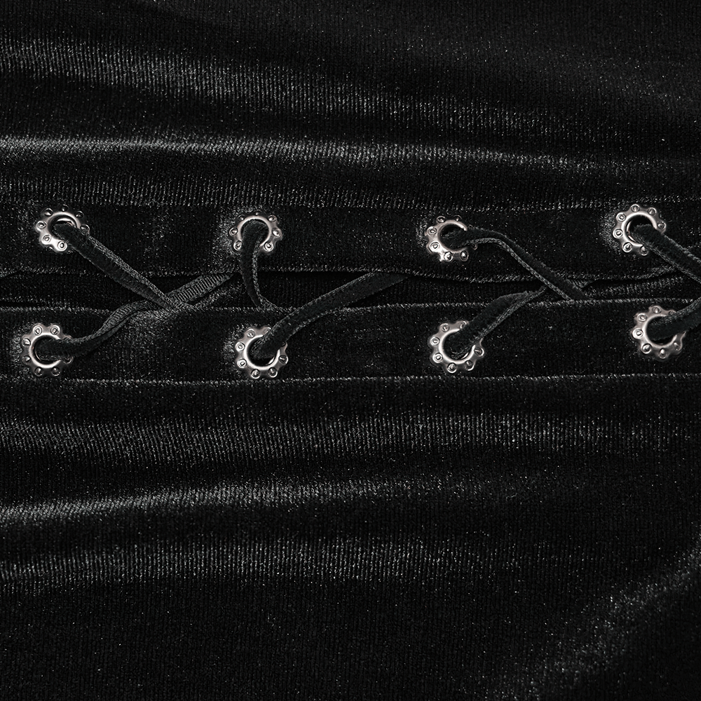 Close-up of black velvet fabric with side drawstrings and silver hardware details, showcasing gothic elegance.