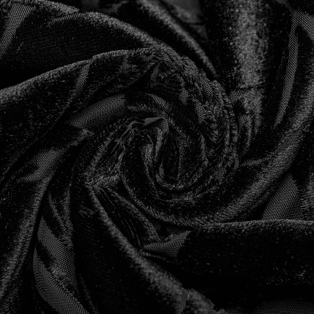 Close-up of luxurious black velvet fabric in a swirling pattern, showcasing its soft texture and elegance.