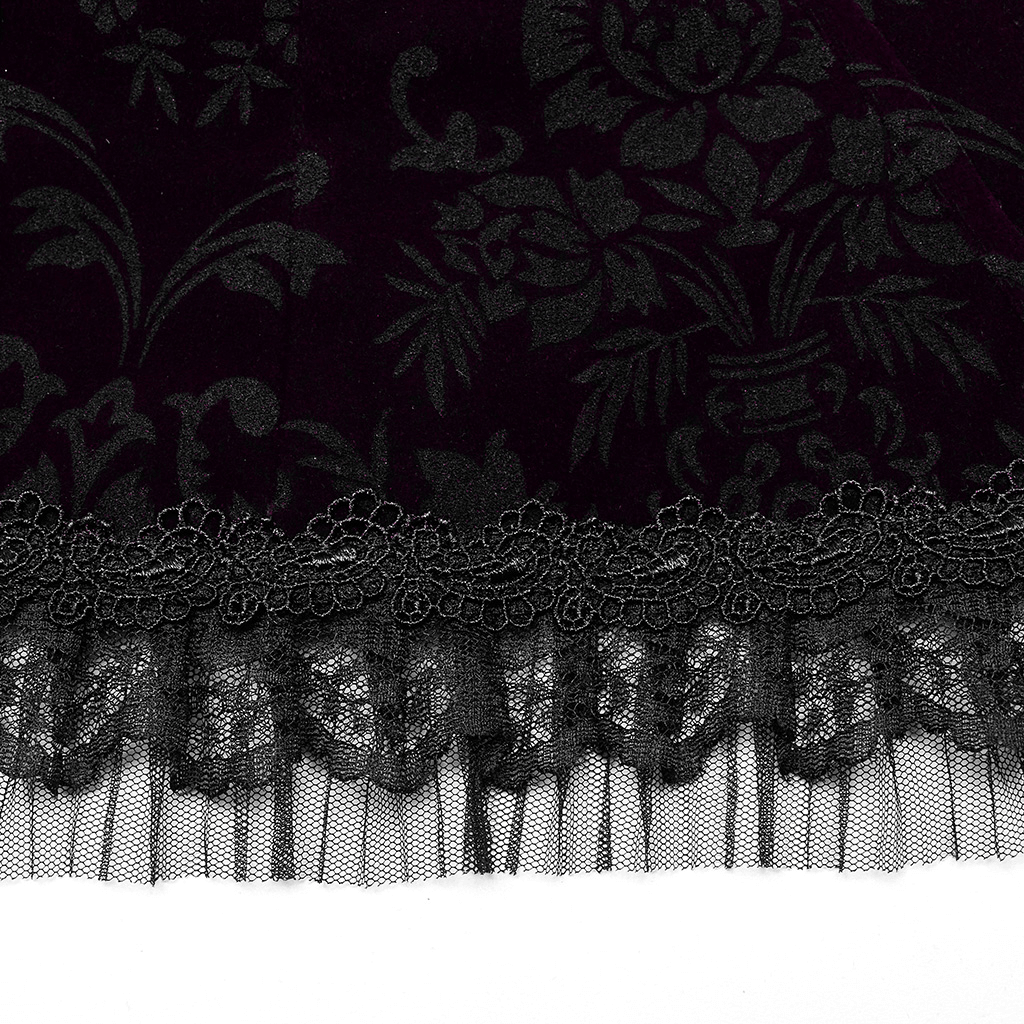 Close-up of luxurious velvet fabric with gothic floral pattern and delicate black lace trim.