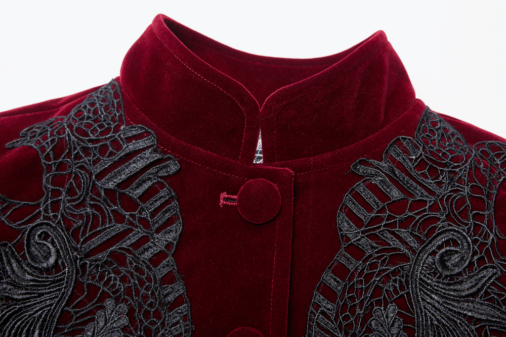 Close-up of a velvet gothic coat featuring intricate lace detailing and a stylish collar.