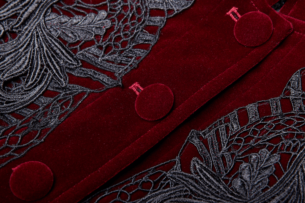 Close-up of burgundy velvet coat featuring intricate Gothic lace and stylish buttons.