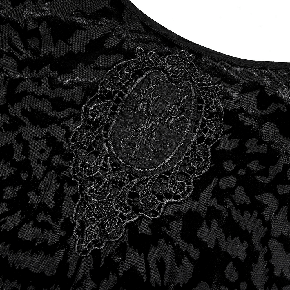 Close-up of black velvet dress with intricate lace embroidery detail, perfect for gothic style lovers.