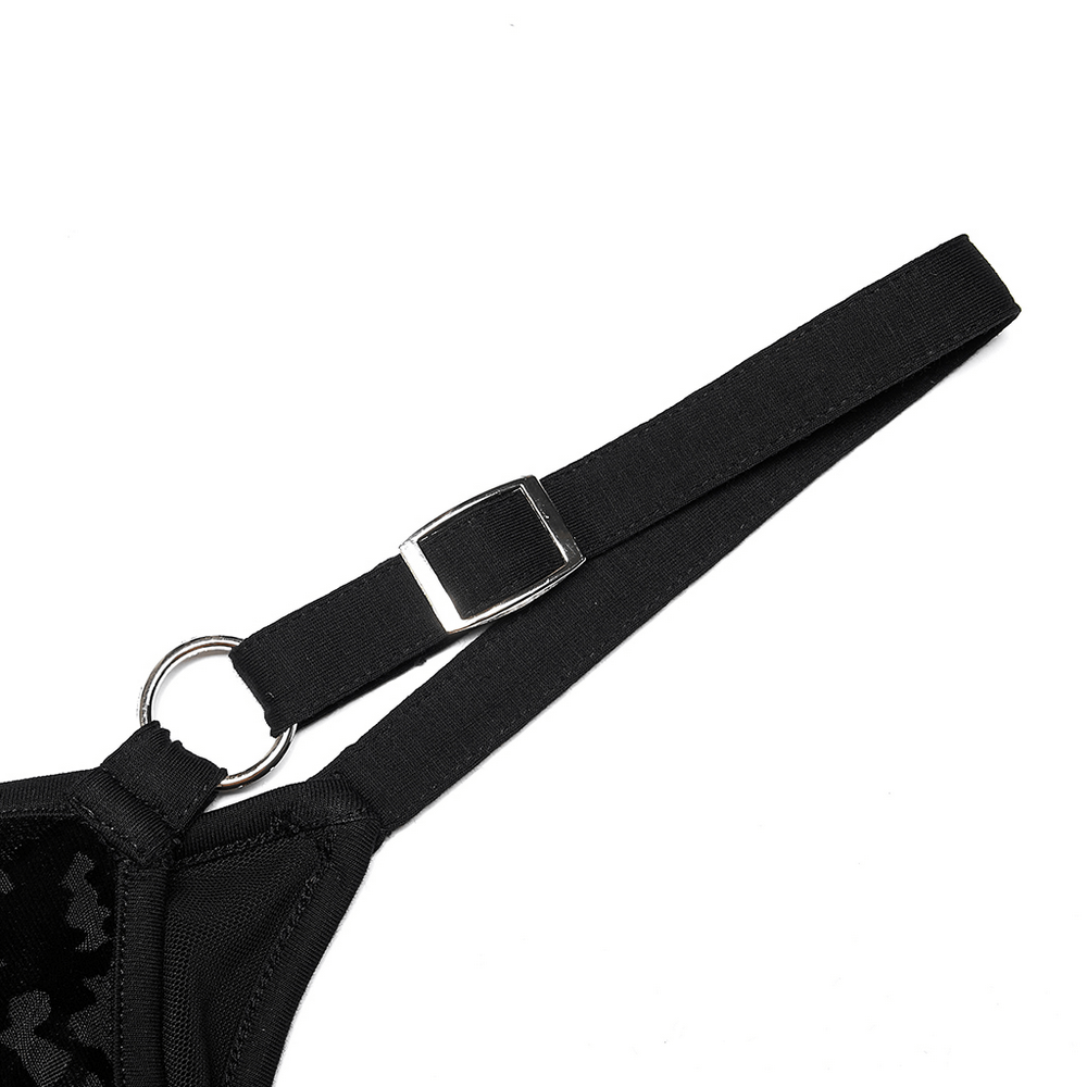 Close-up of the adjustable strap on a velvet gothic dress, featuring a removable leather loop for easy maintenance.
