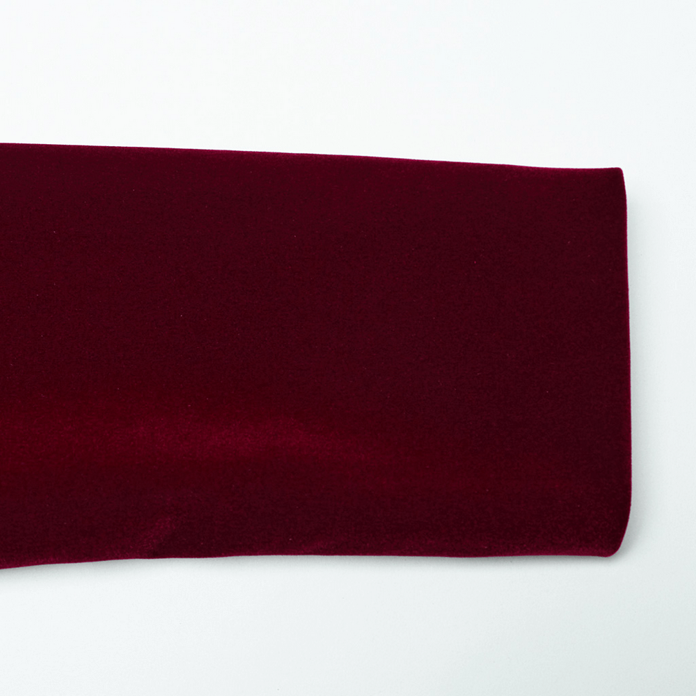 Luxurious burgundy velvet fabric showcasing softness and rich texture for gothic fashion.