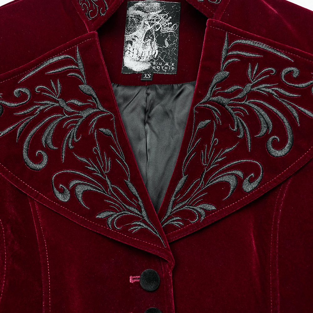 Close-up of velvet gothic jacket with embroidered stand collar, showcasing intricate patterns and detailed buttons.