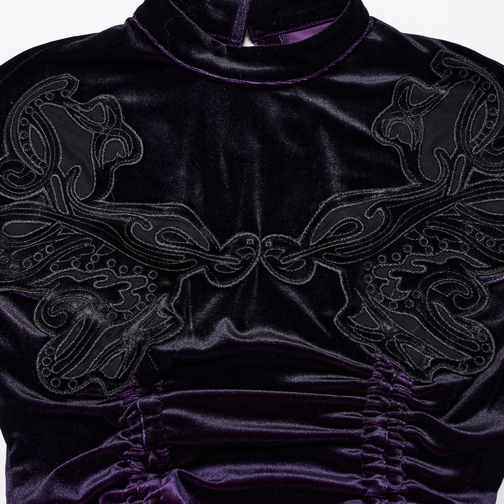 Elegant velvet fabric with intricate black embroidered detail on a Gothic dress's bodice.