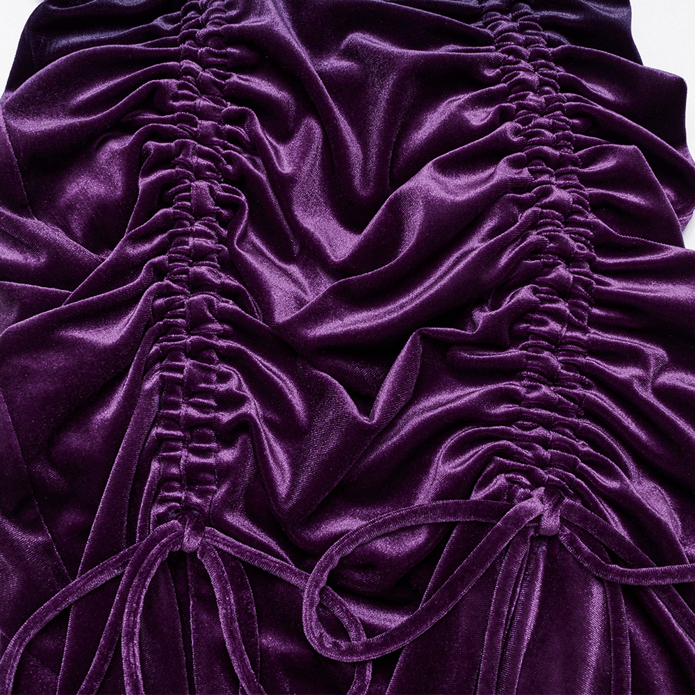 Close-up of luxurious purple velvet fabric with intricate adjustable drawstrings, showcasing pleated details.
