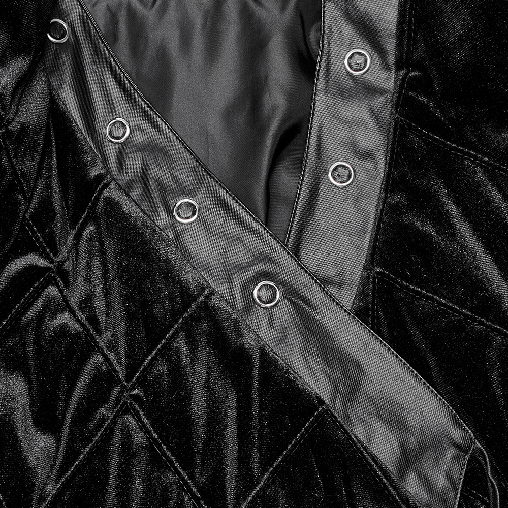 Close-up of the quilted black velvet interior and snap closures of a Gothic long coat.