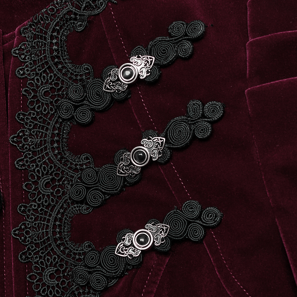 Close-up of ornate lace and engraved buttons on a luxurious velvet gothic jacket.
