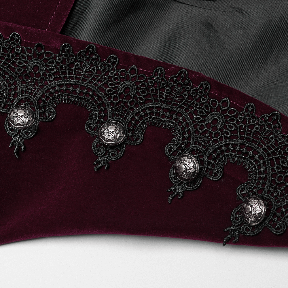 Close-up of luxurious velvet gothic jacket with intricate lace detailing and ornate engraved buttons.