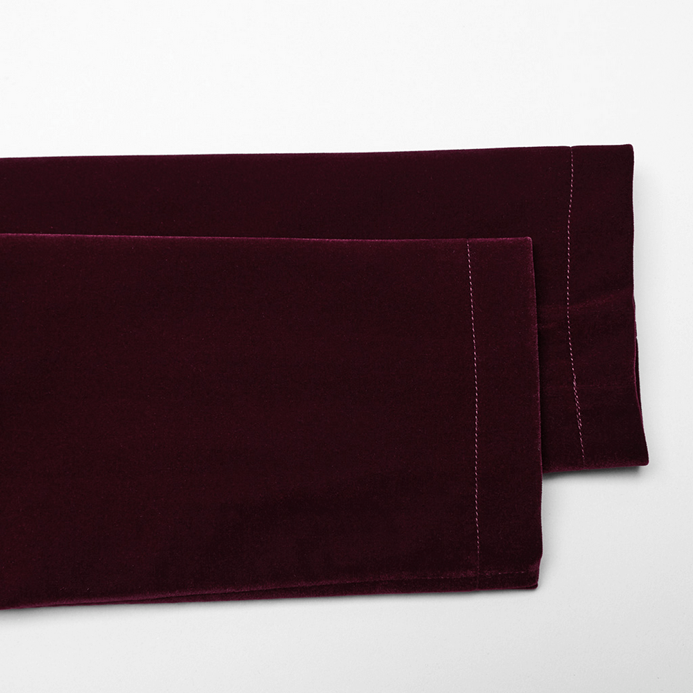 Luxurious burgundy velvet fabric showcasing elegant texture and rich color, perfect for gothic fashion.