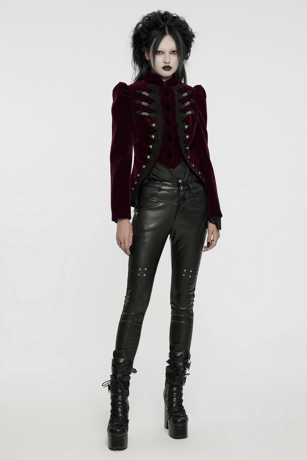 Luxurious velvet gothic jacket with lace-up back and button accents, styled with edgy black leather pants.