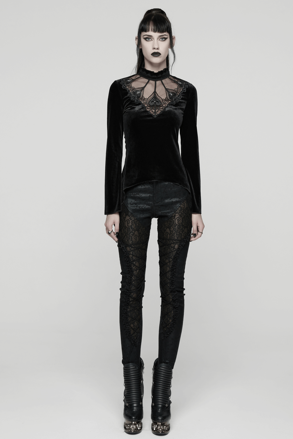 Model wearing Velvet Gothic Top with Sheer Lace and Ruffled Collar paired with stylish black pants.