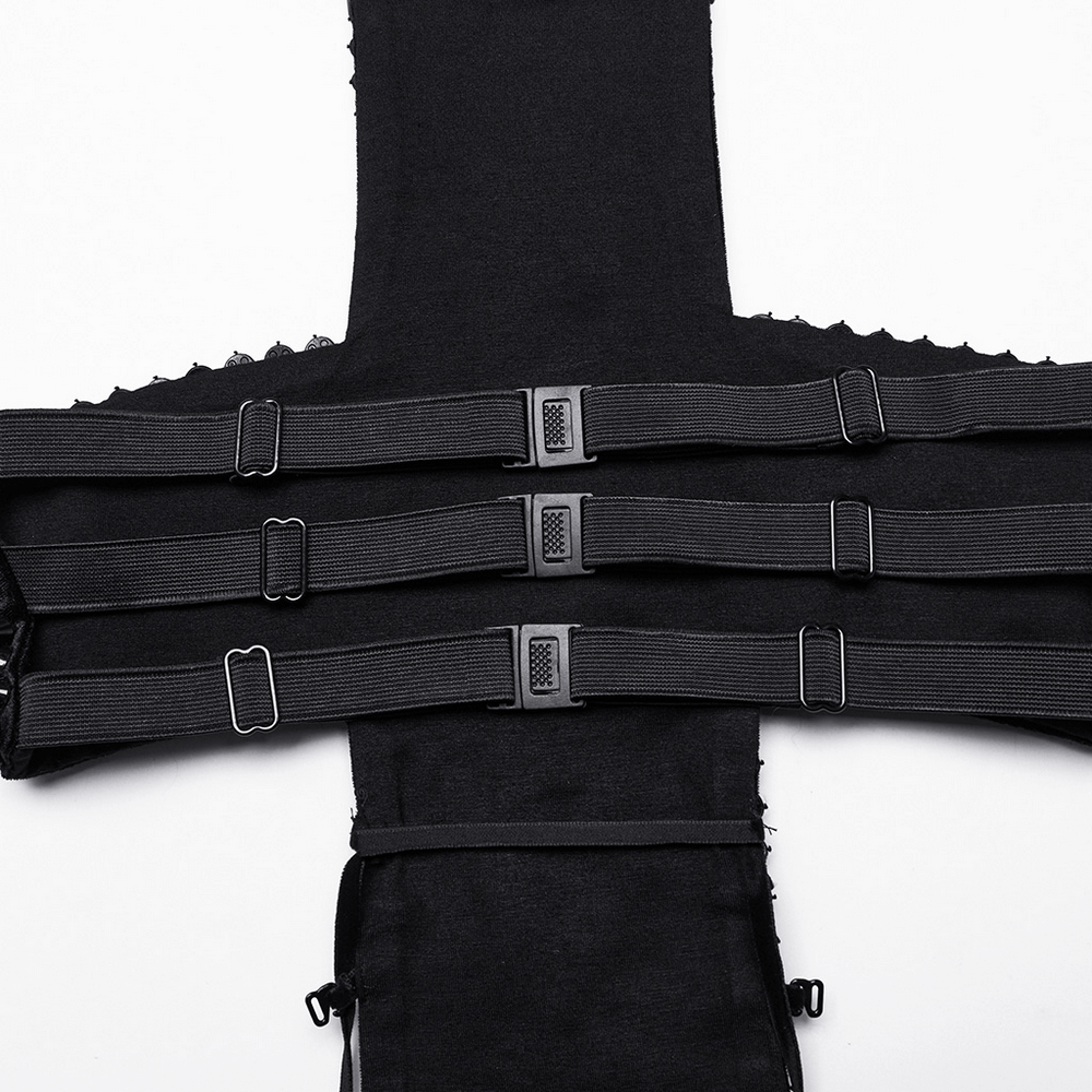 Close-up of spiked rivet halter top with multiple adjustable buckle straps in black velvet.