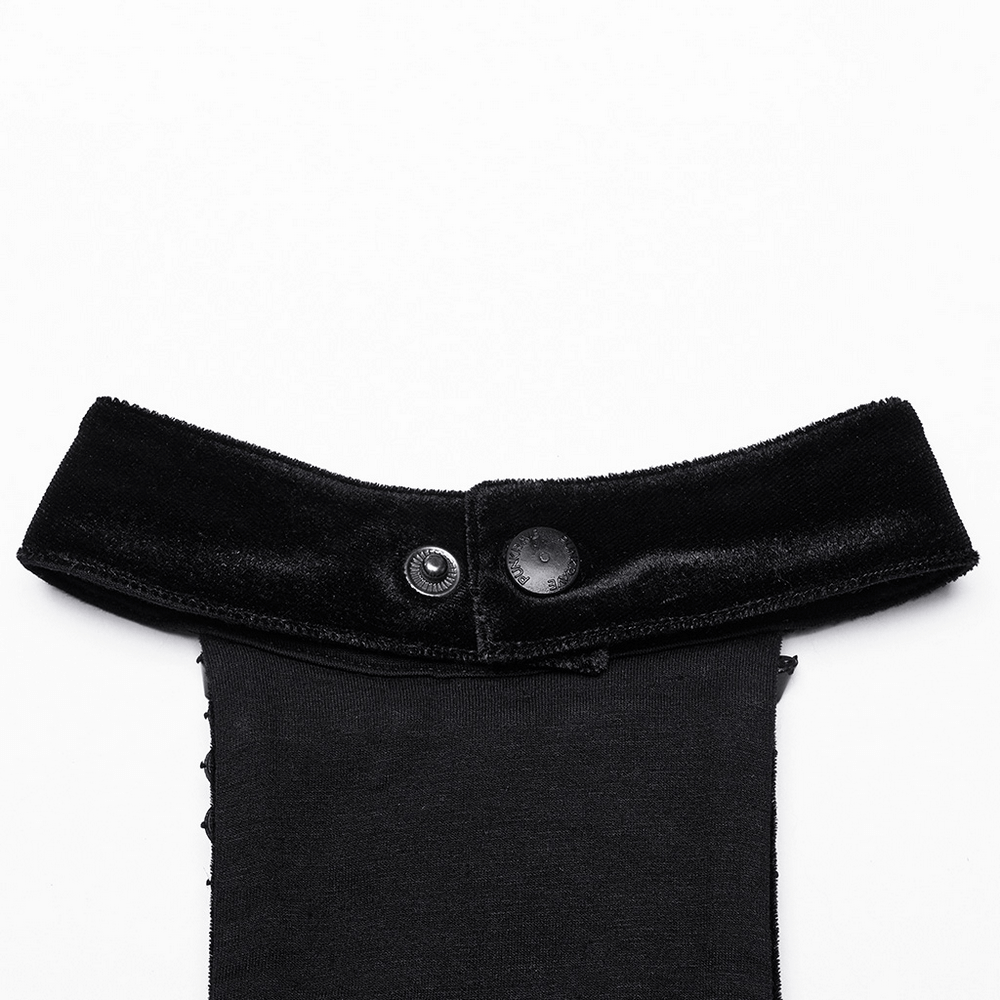 Close-up of black velvet halter top collar with buttons showcasing gothic style and futuristic design elements.