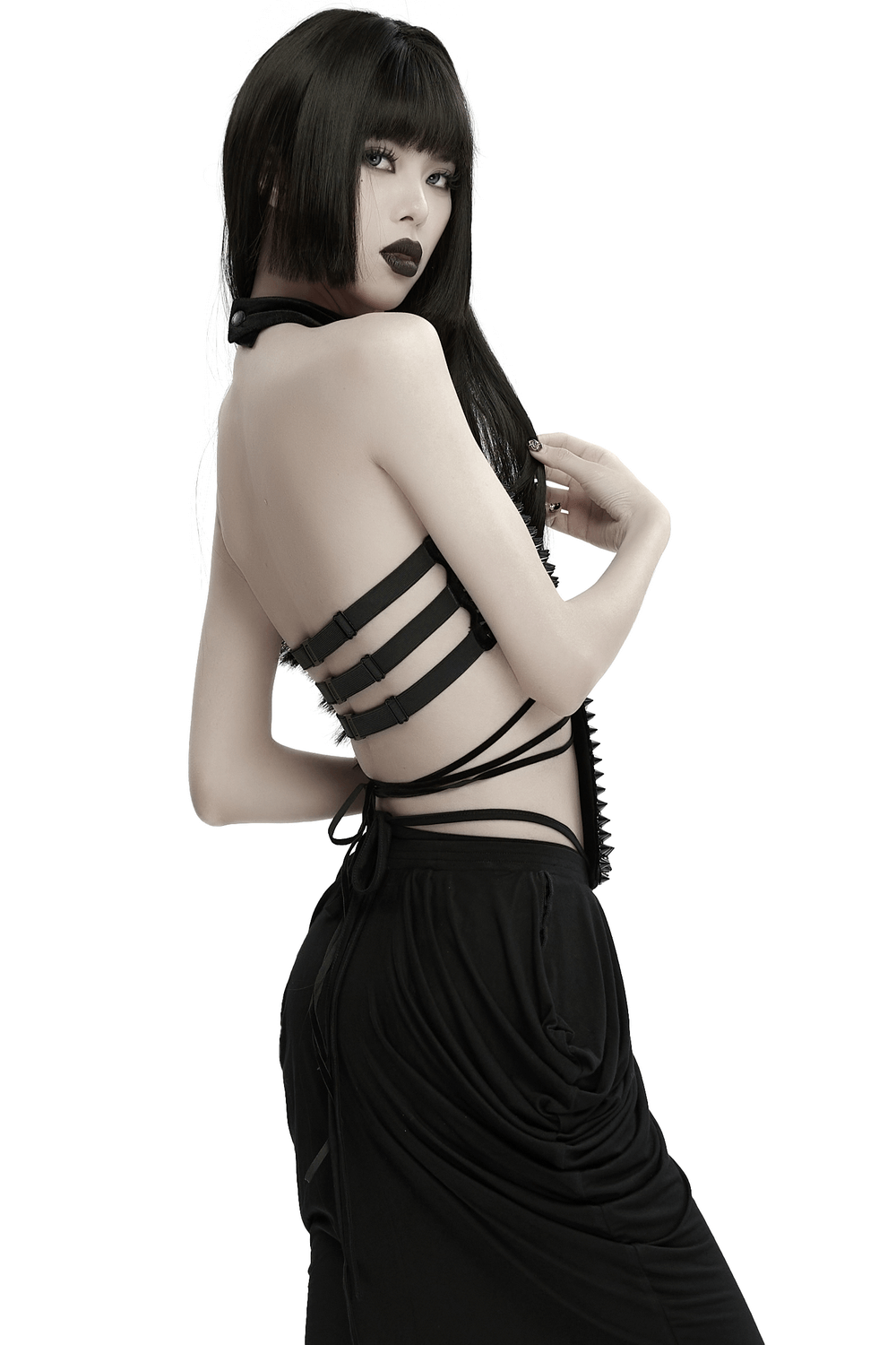 Gothic velvet halter top with spiked rivets and waist straps, showcasing a bold, avant-garde design.