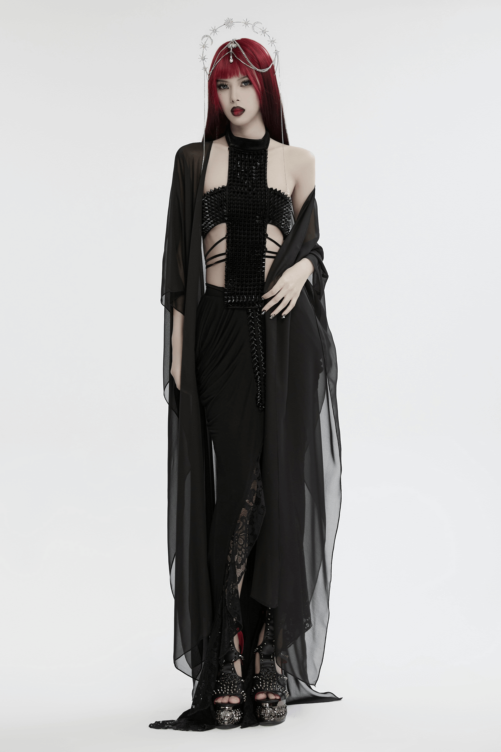 Model in a striking black velvet halter top with spiked rivets, showcasing gothic and futuristic vibes