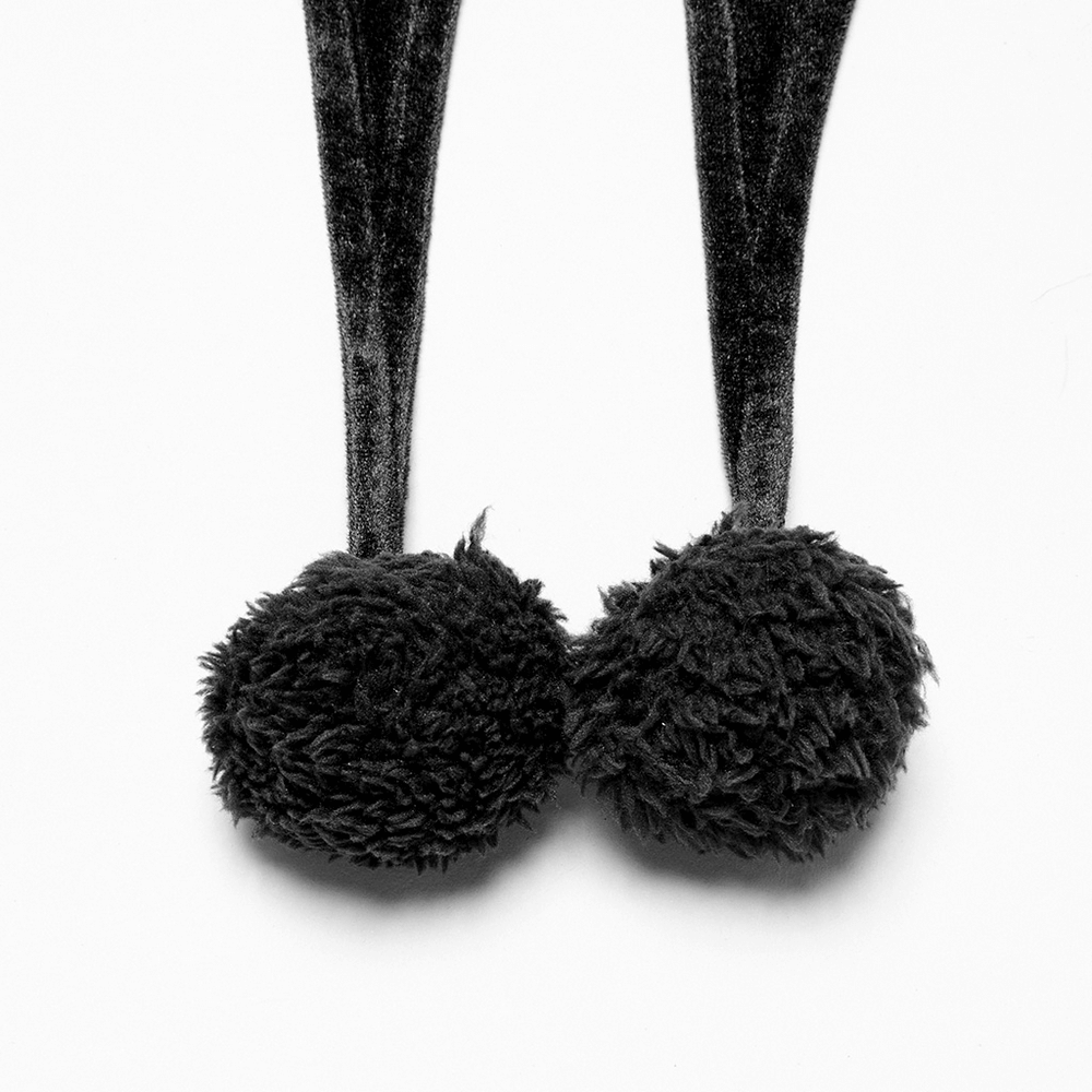 Close-up of playful fur balls on a velvet hooded cape, adding charm and flair for fantasy cosplay.
