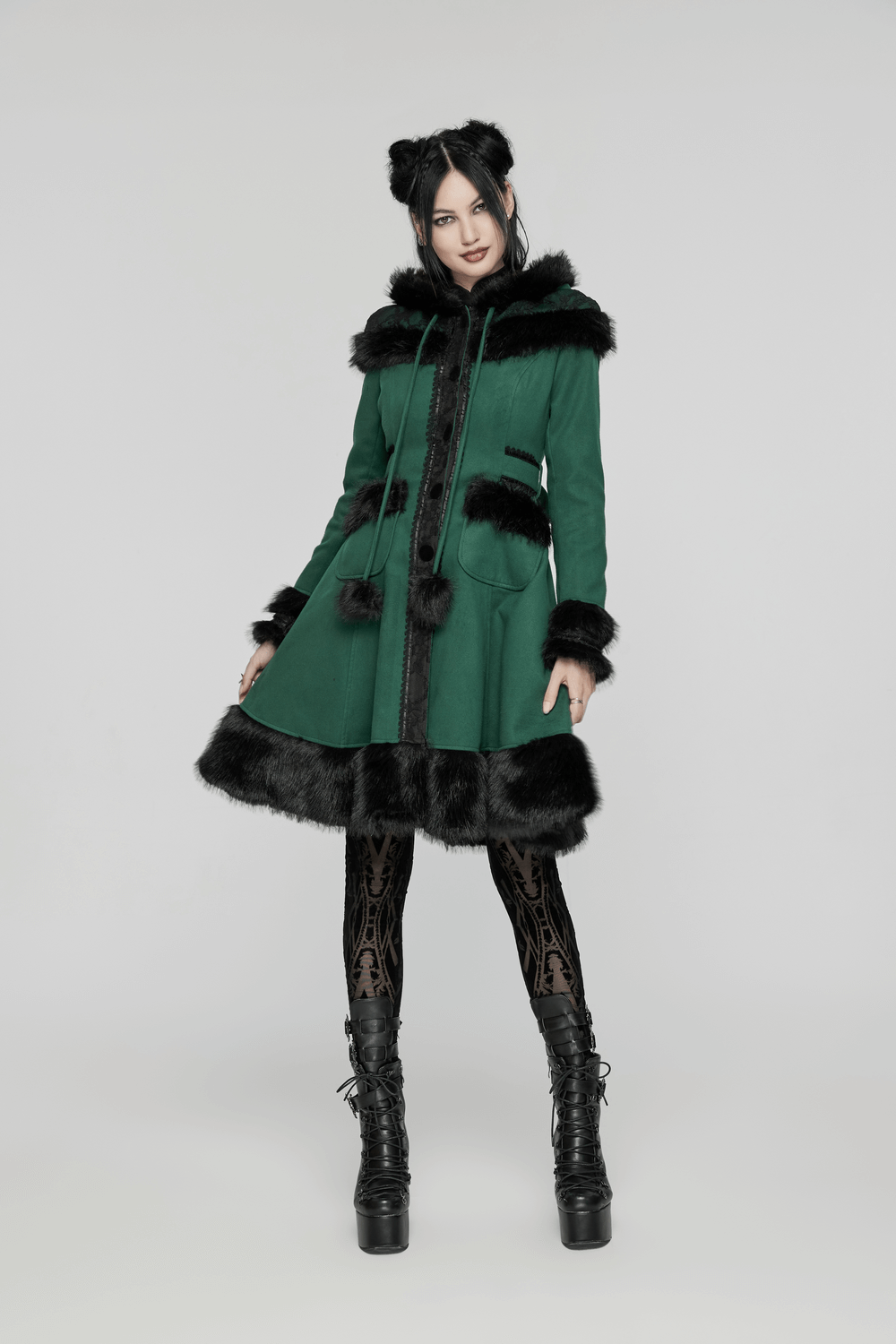 Elegant green velvet hooded coat with faux fur trim and playful bow accents, styled with chic boots and patterned leggings.