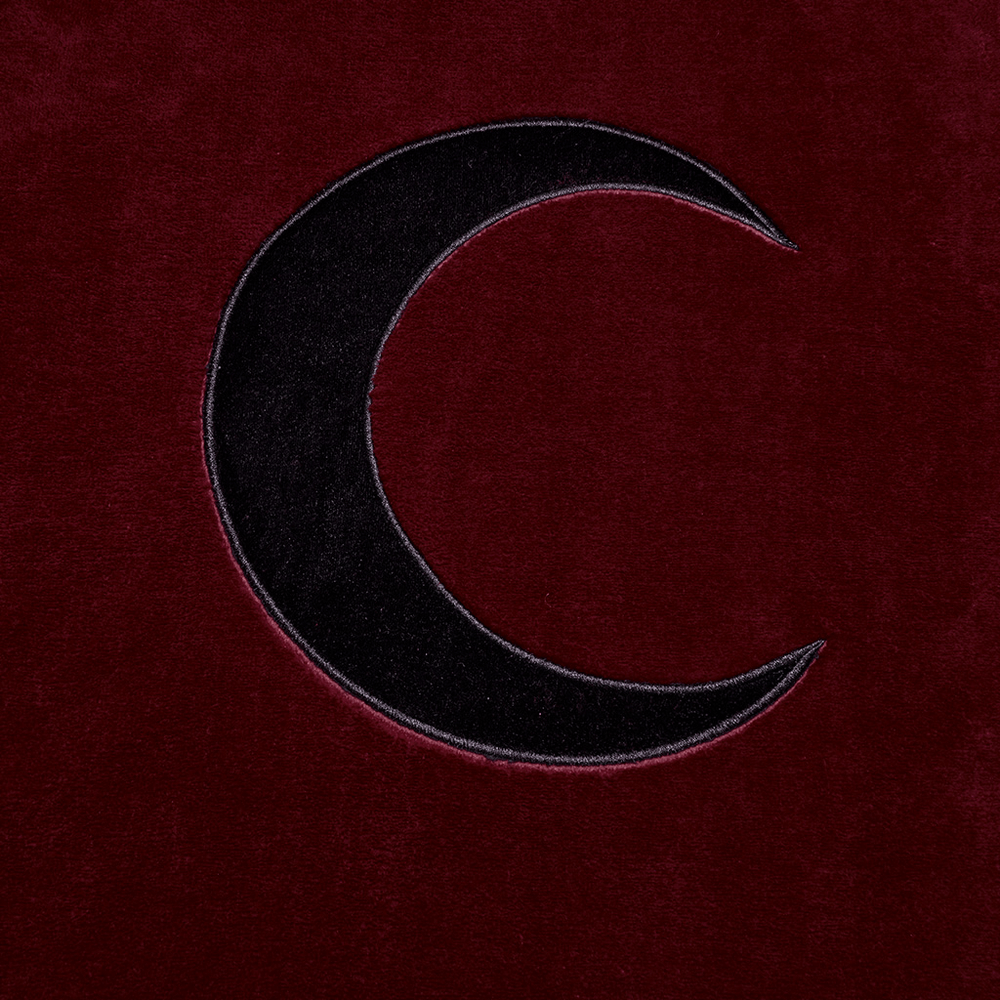 Dark velvet fabric featuring a stylish black crescent moon embroidery, perfect for a mystical look.