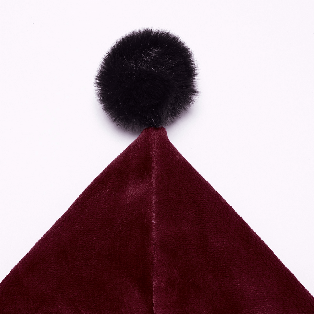 Close-up of maroon velvet hood with a fluffy black pom pom, perfect for a cozy, stylish look.
