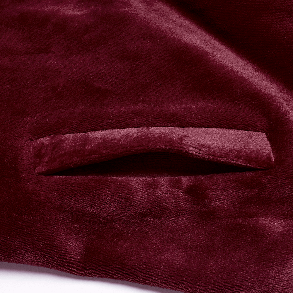 Close-up of luxurious dark velvet fabric showcasing the soft texture and hidden pocket detail of the moon cape.