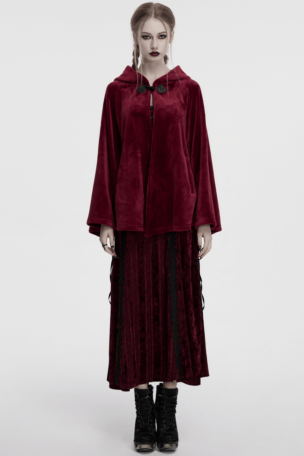 Model wearing a dark red velvet hooded moon cape, showcasing mystical style and elegance with flowing sleeves.