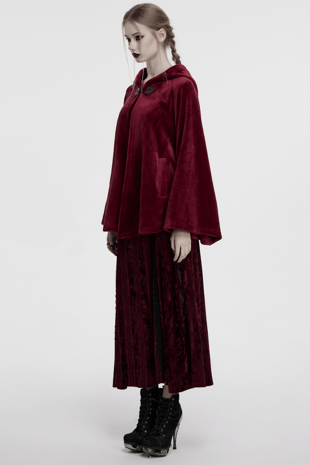 Dark velvet hooded moon cape worn by model, showcasing flowing style and unique embroidery detail.